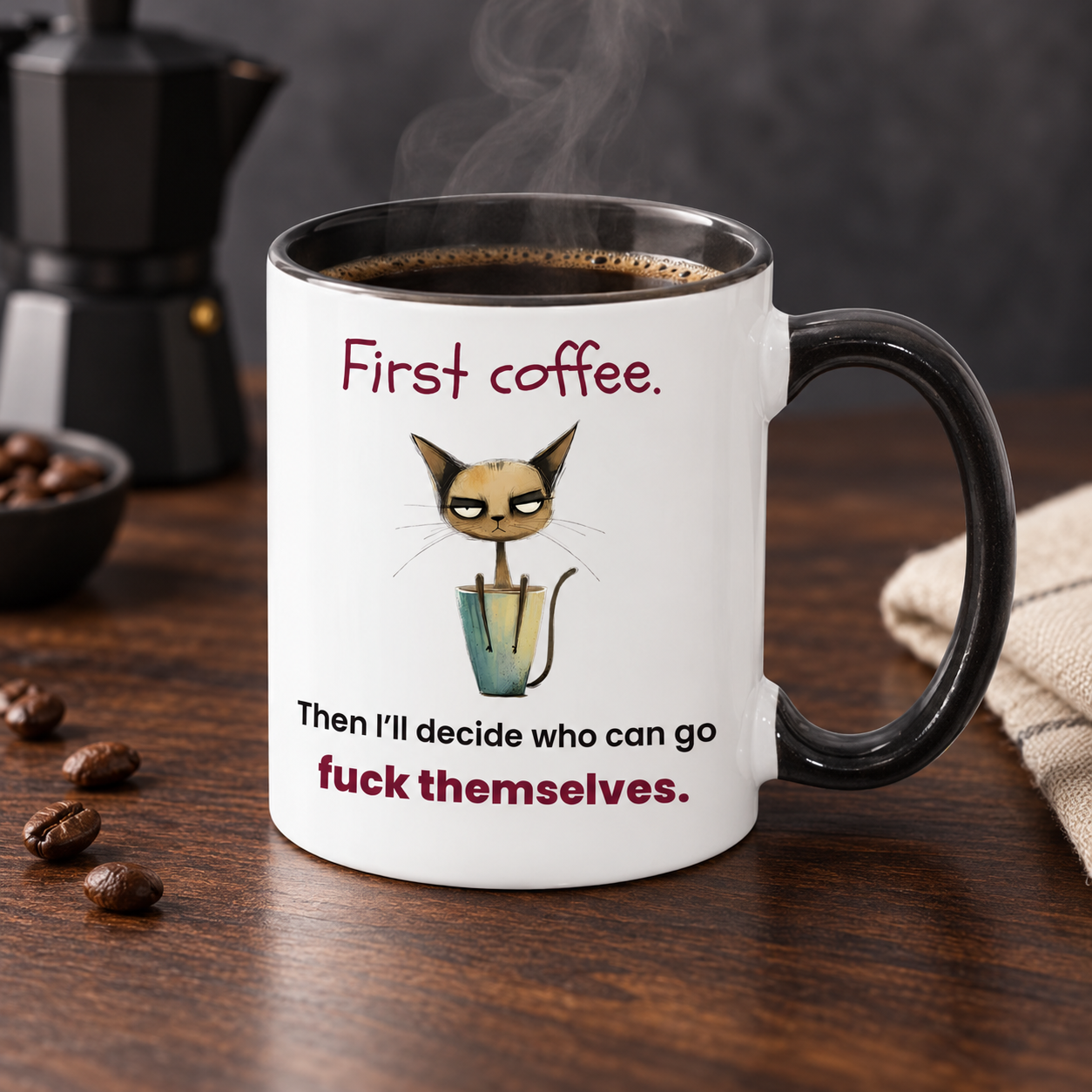First Coffee sarcastic cat mug displayed on a dark walnut coffee bar with a black handle, steaming coffee and its complete wording visible.